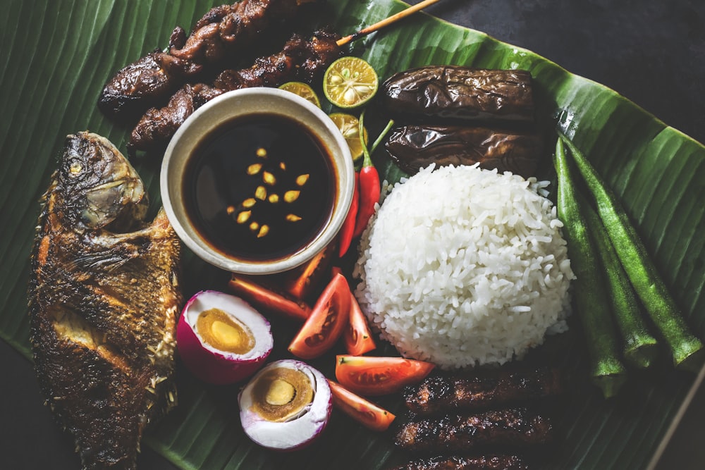 variety of fried dishes on banana leaf