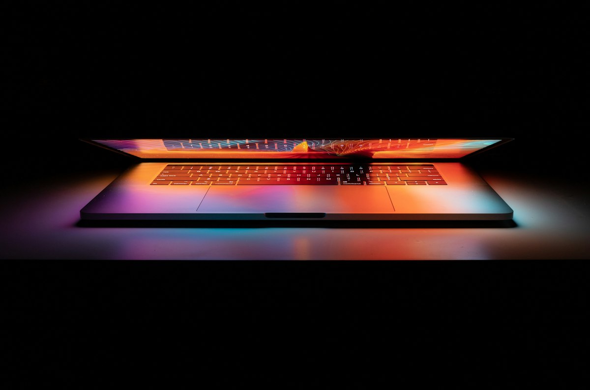 Laptop glowing in a dark room