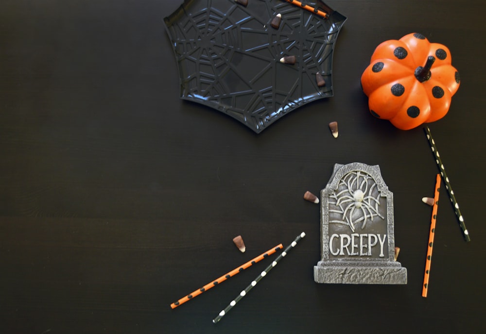 a halloween decoration with a tombstone and candy sticks