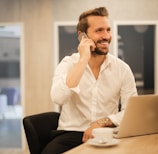 man using smartphone on chair