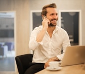 man using smartphone on chair