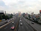 A panoramic view of a high-traffic highway lined with vibrant Adfinity digital billboards.