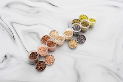 A set of colorful boobiz interchangeable cups in pastel shades laid out on a soft nude fabric.