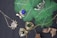 An assortment of jewelry is arranged on a dark surface with vibrant green leaves. The collection includes necklaces with intricate designs featuring gemstones. Notable pieces include a spider-shaped pendant with a white gemstone and a necklace with a large blue stone surrounded by smaller pearls. Another item is a silver pendant with branch-like elements. The background contrasts with dried leaves adding a natural element.