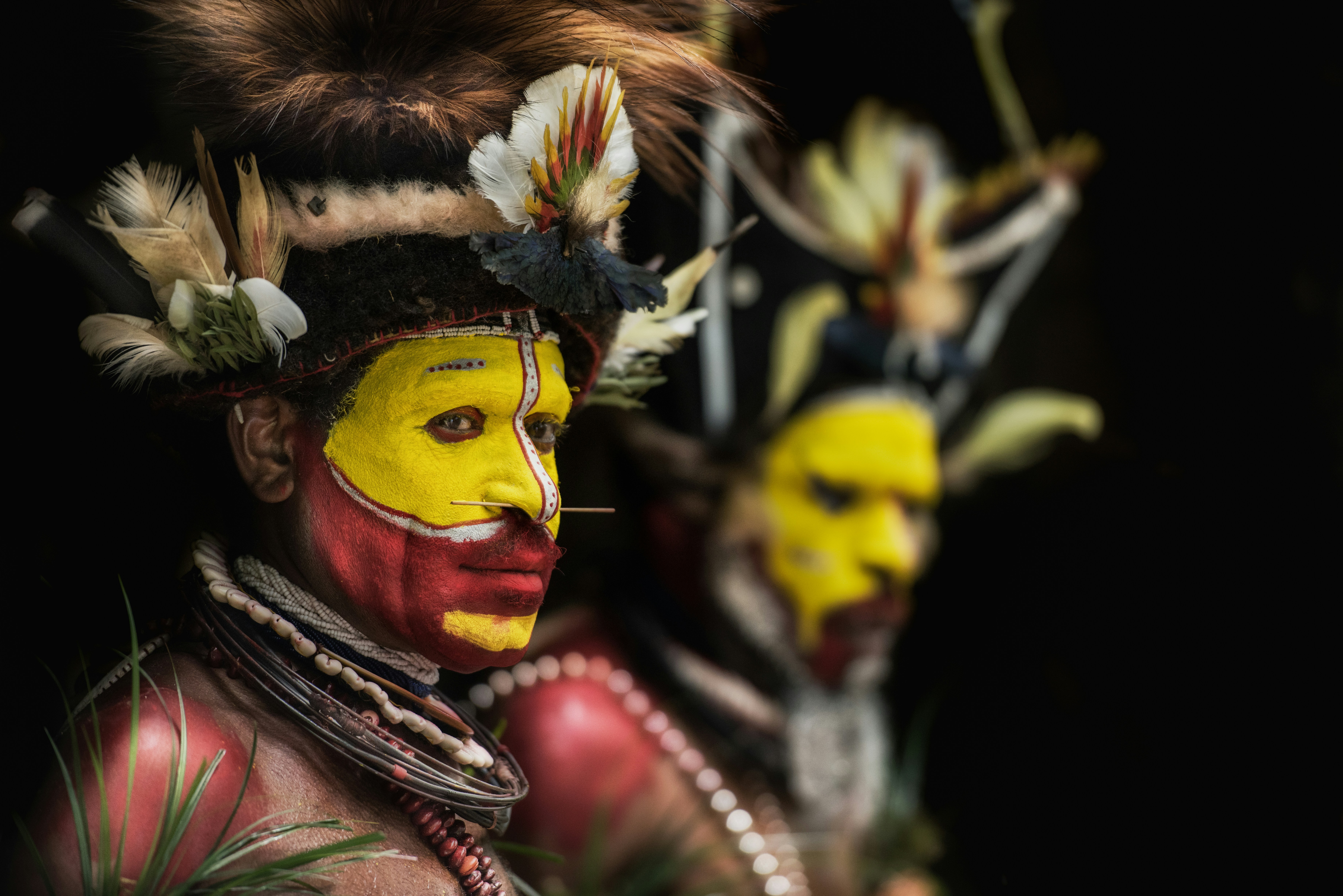 man with yellow and red face paints