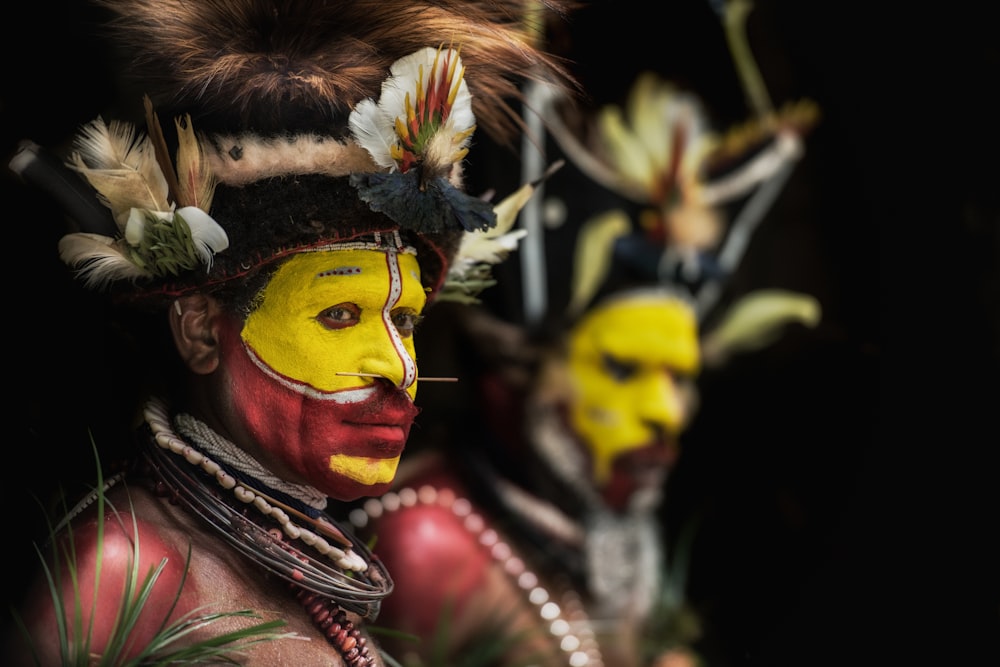 man with yellow and red face paints