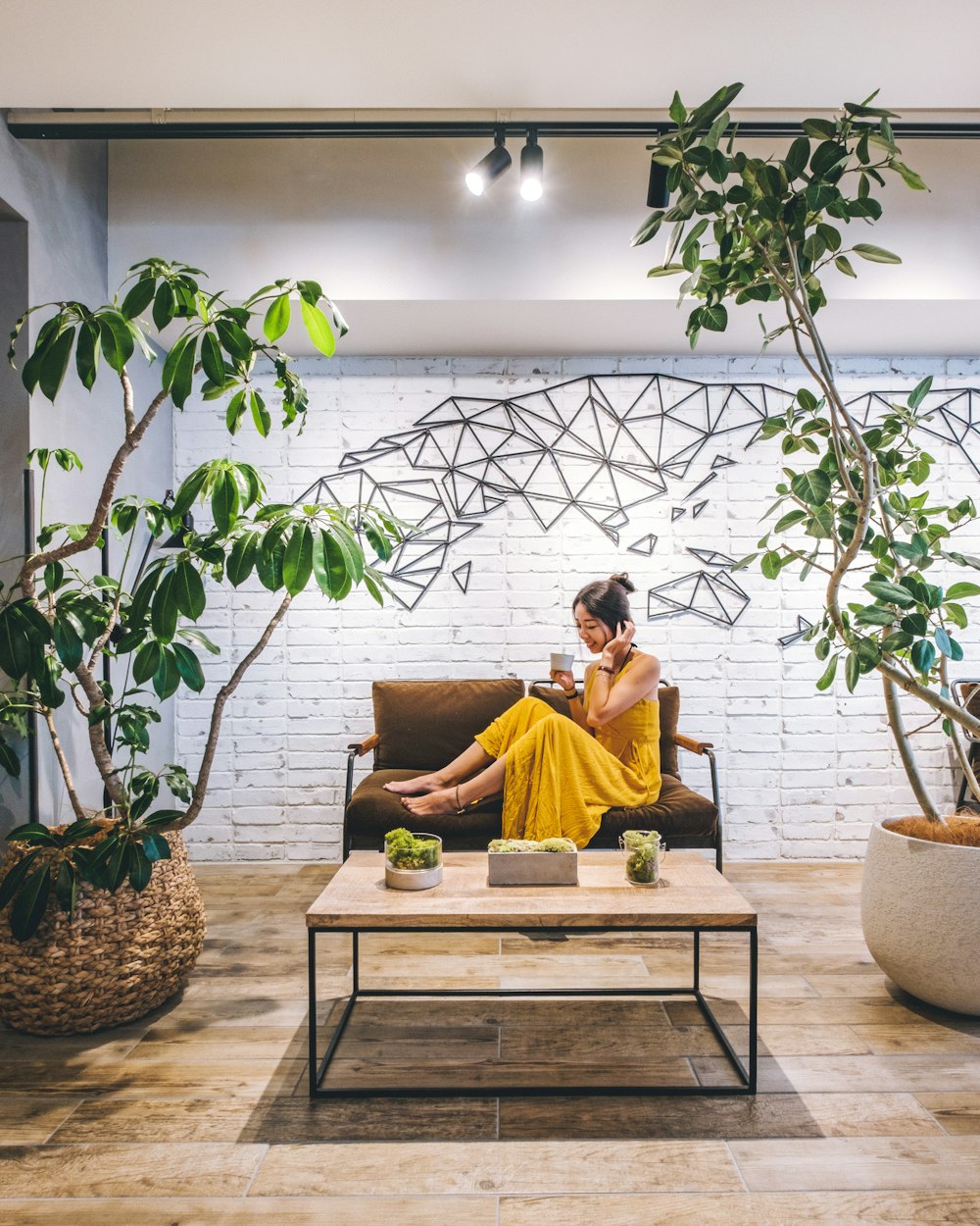 smiling woman sitting on brown sofa