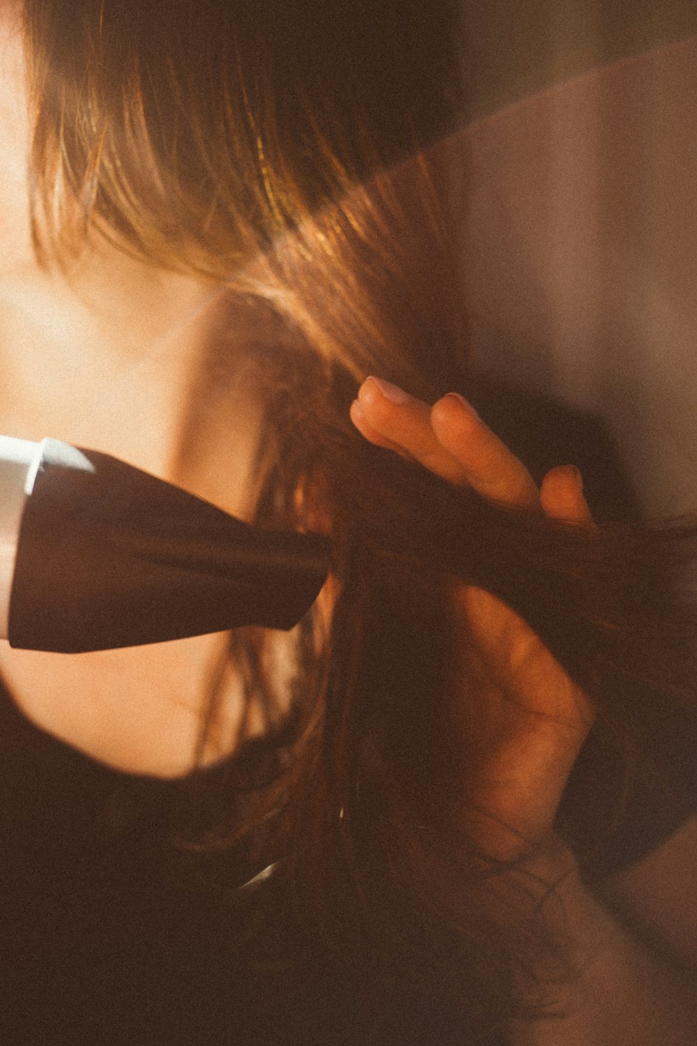 woman blowdrying hair