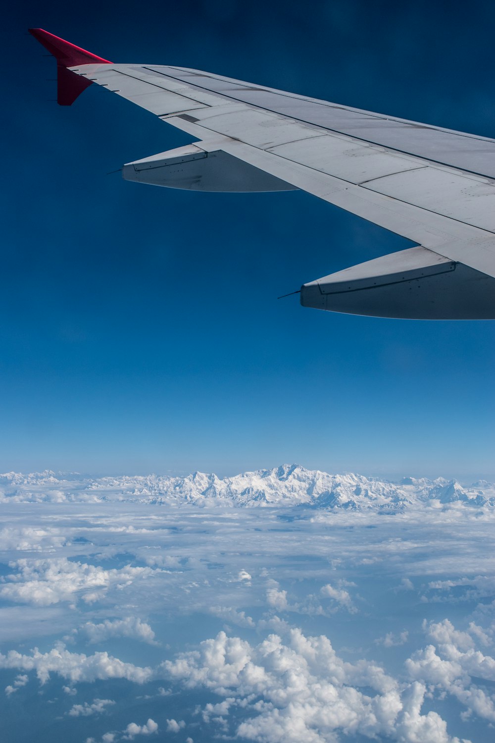 white airplane flying in the sky