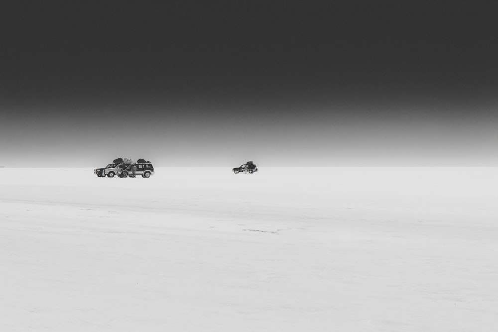 three vehicles on sand