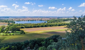 A serene landscape showing fresh rain nourishing green fields under a bright sky.