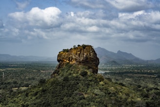 brown rock mountain under cloudy sky