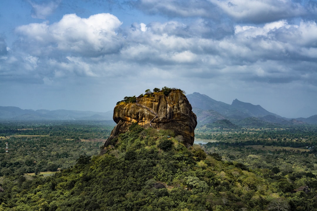 brown rock mountain under cloudy sky