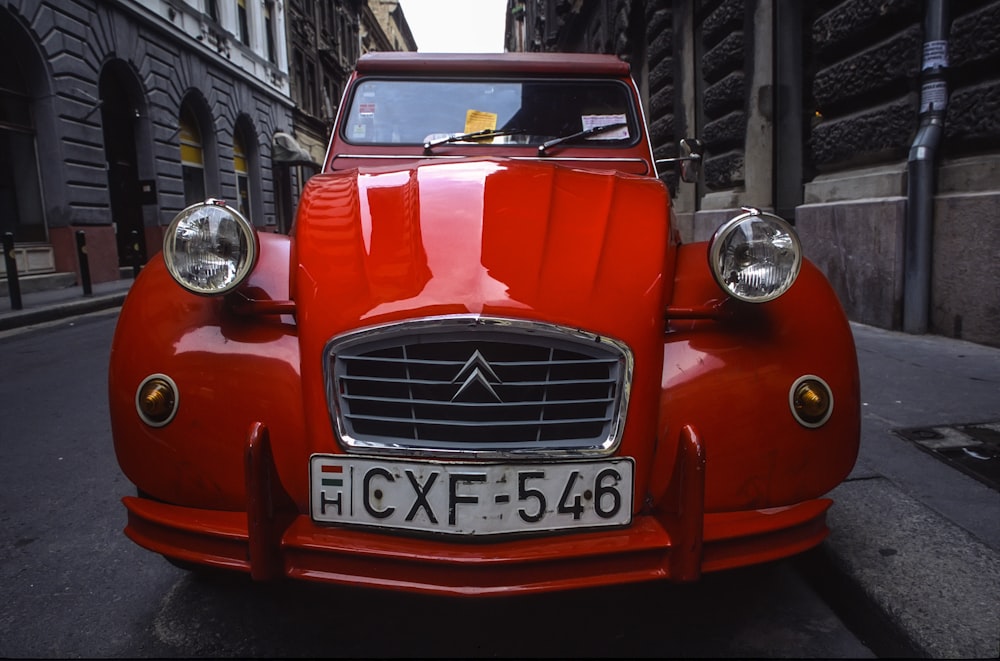 red Citroen car parked on road