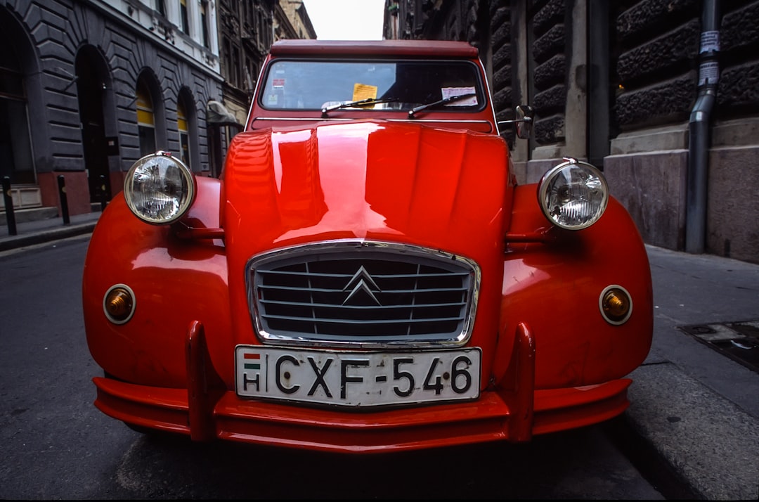 red Citroen car parked on road