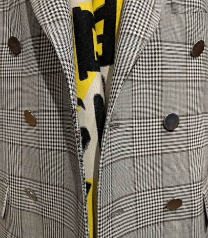 Close-up of rosé gold buttons on a sleek Lumina Apparel blazer.