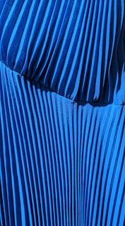 A close-up view of various pleated materials showing texture and color.