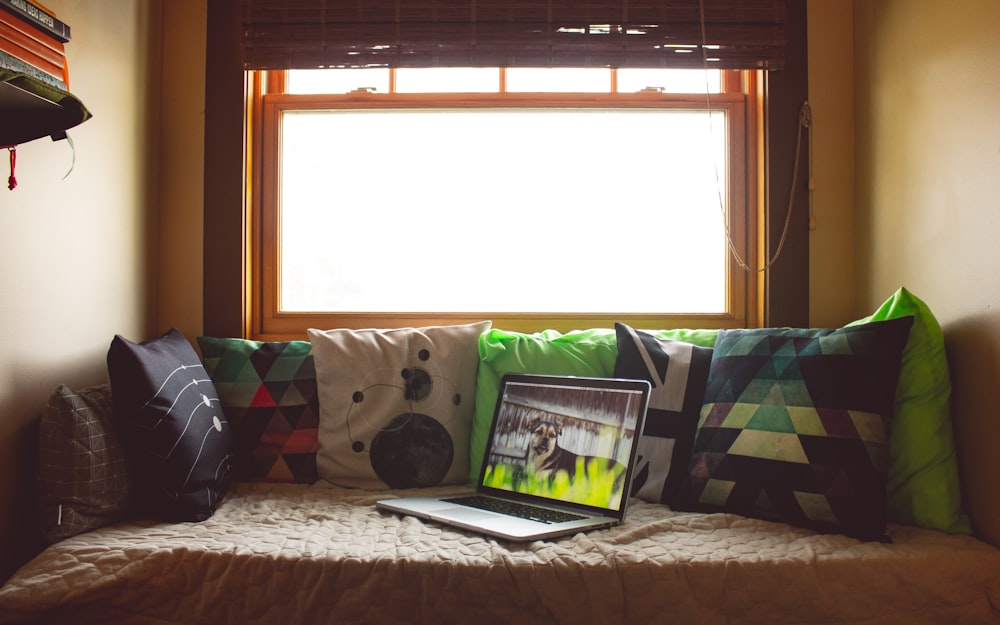 silver laptop on couch