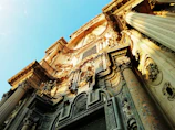 Close-up of detailed baroque carvings on historic village buildings.