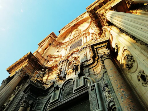 Close-up of detailed baroque carvings on historic village buildings.
