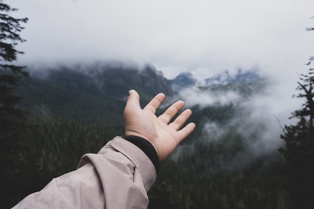 person raising left hand