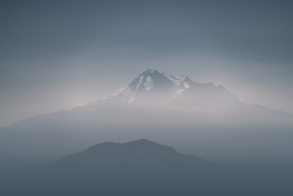 bird's eye view of mountain coated with fogs
