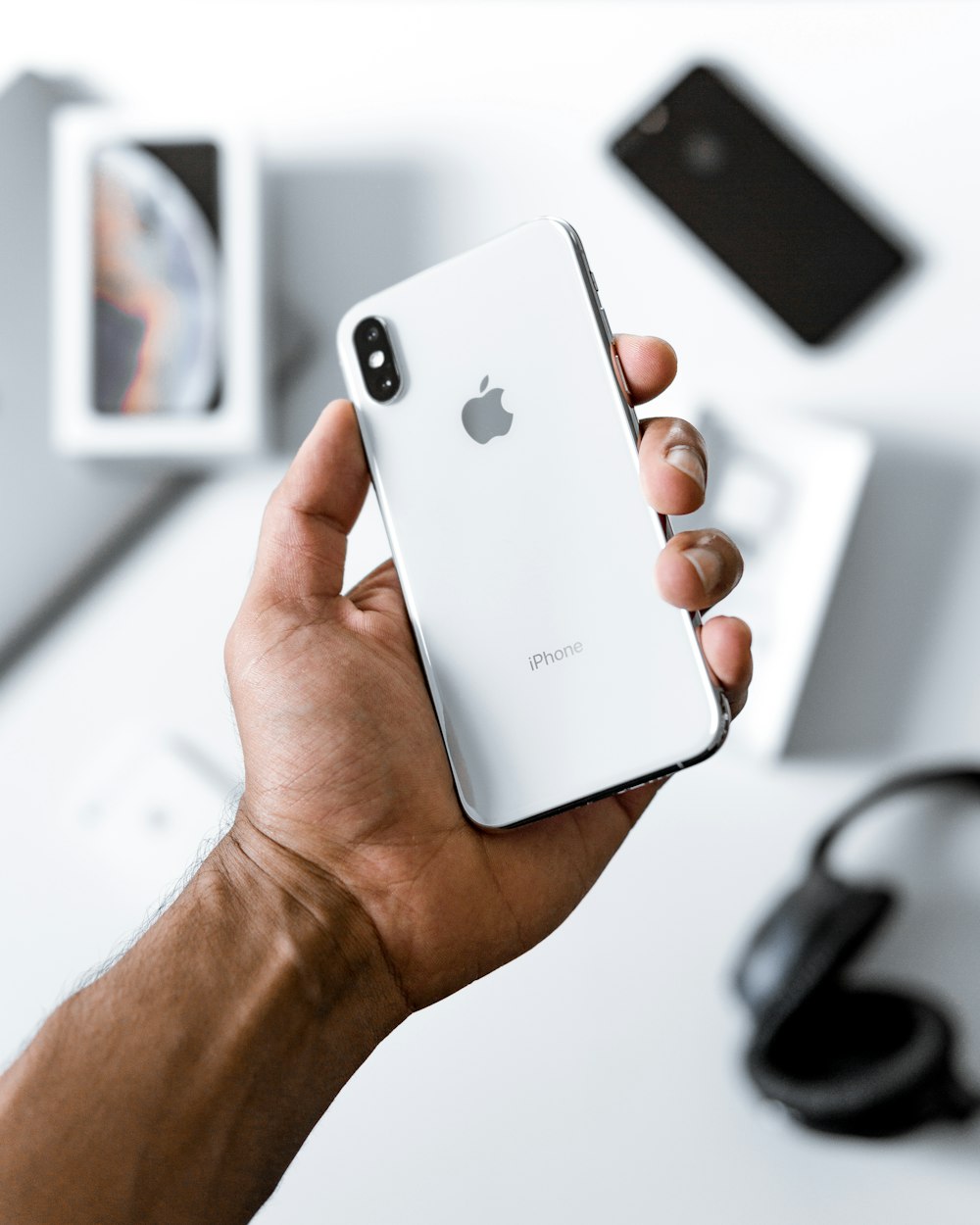 person holding silver iPhone X