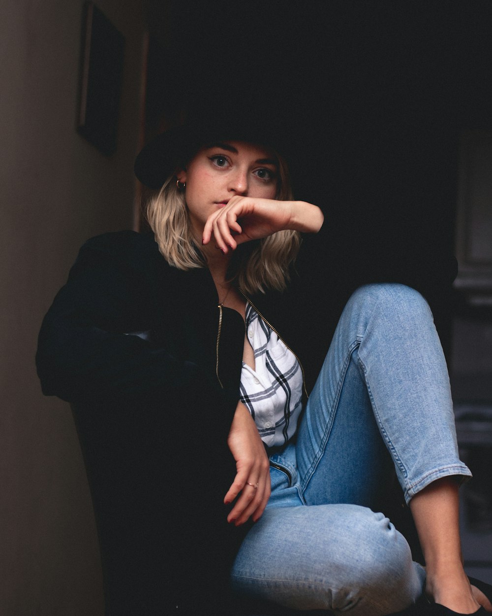 woman in blue jeans and black jacket