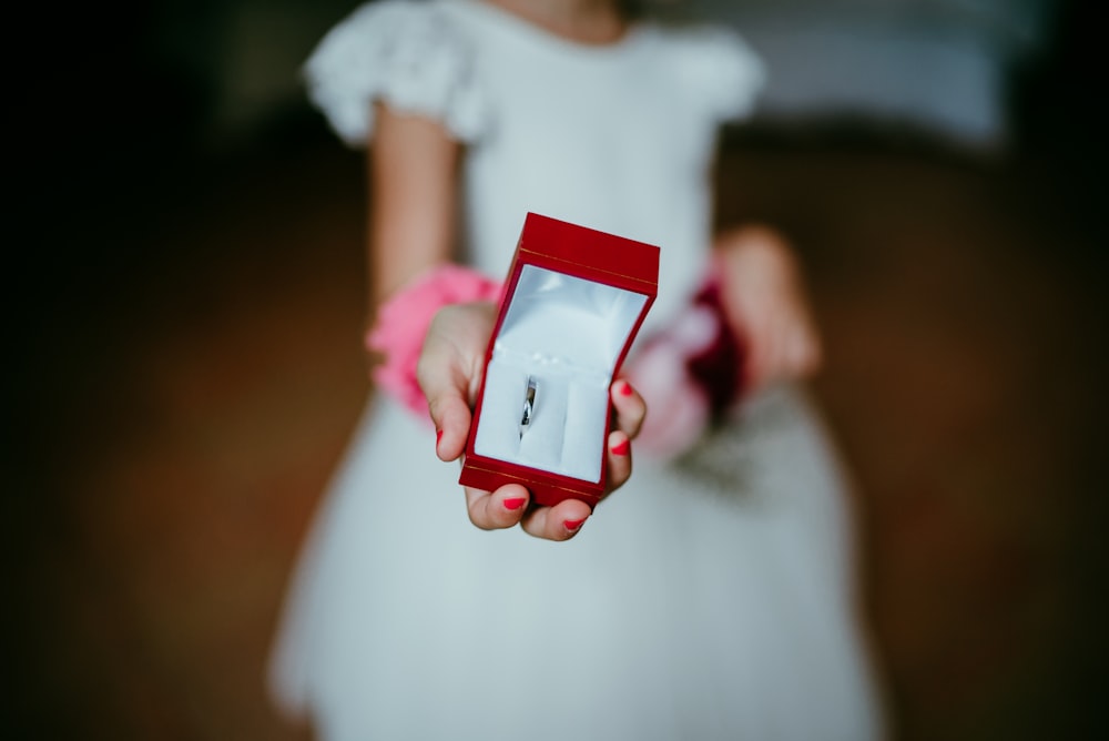 kid holding red ring box