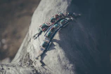Close-up of handcrafted spiritual jewelry laid out on natural wood with soft sunlight