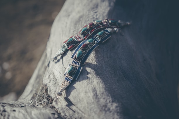 Handcrafted wooden jewelry displayed on a rustic table with natural lighting
