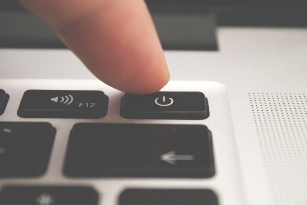 close-up photo of human finger pointing turned-off switch