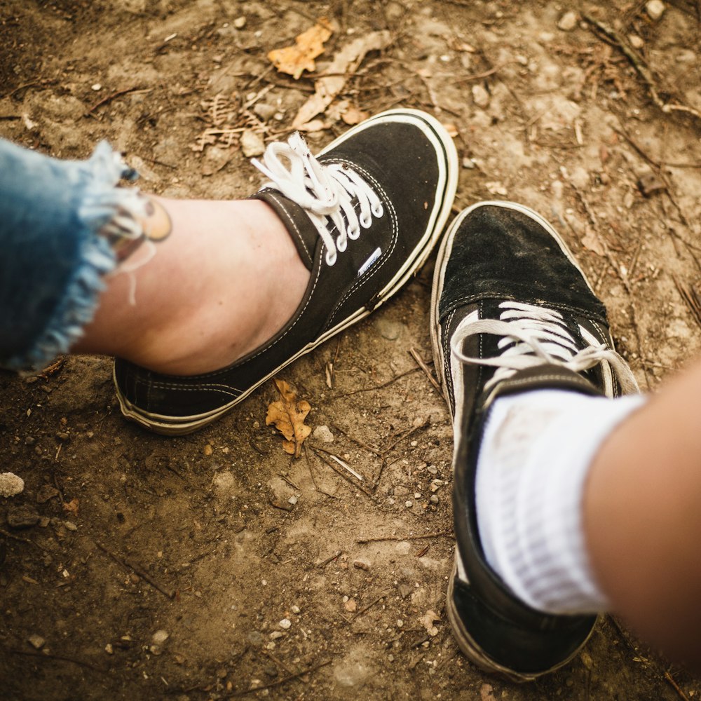 two person wearing black and white low-top sneakers