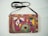 A close-up photo of a handmade embroidered bag with intricate stitching and vibrant colors.