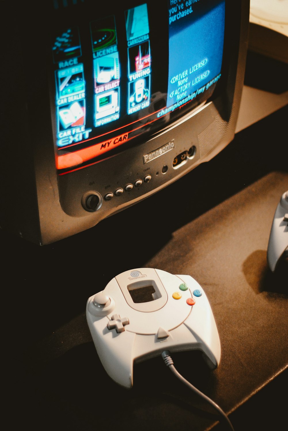 white corded game controller on brown surface