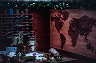 A cozy home office with travel maps and souvenirs scattered around, reflecting a personal travel agency vibe.