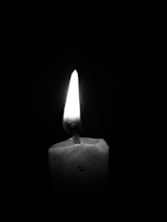 Artistic black and white image highlighting the natural imperfections of soy frosting on a candle’s surface.
