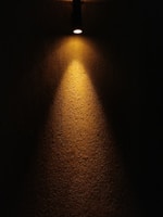 Wallwasher LED lights illuminating a textured wall in a stylish interior.