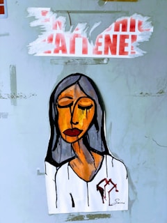 A painted artwork of a person with closed eyes and a somber expression, featuring bold lines and shades of orange, brown, and black. The background is a light, textured surface, with torn red and white text above the figure.