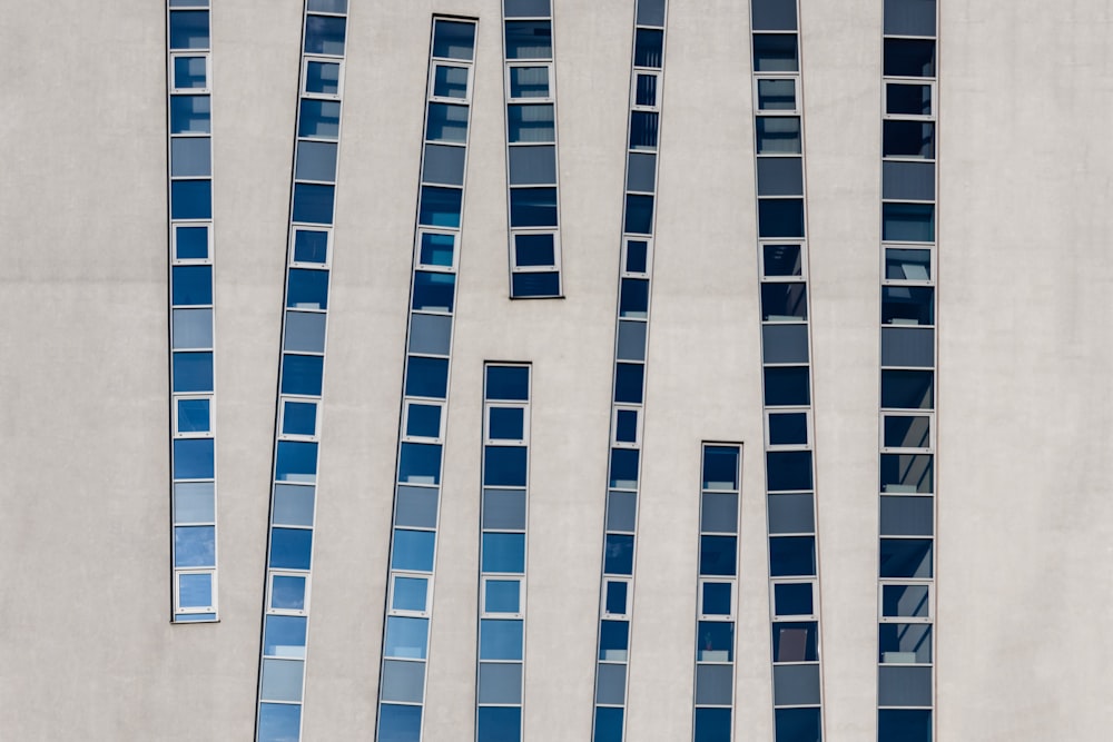 a tall building with lots of windows next to a parking meter