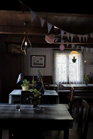 A cozy Scandinavian-style restaurant corner with soft textiles and fresh herbs, highlighting the atmosphere we help promote.