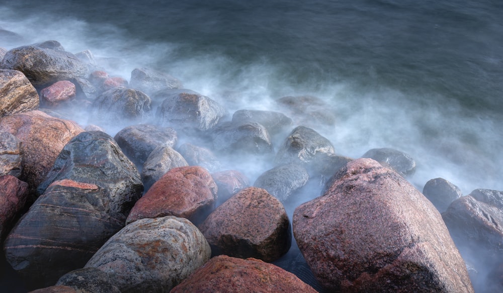 brown and gray rock formation near body of water during daytime