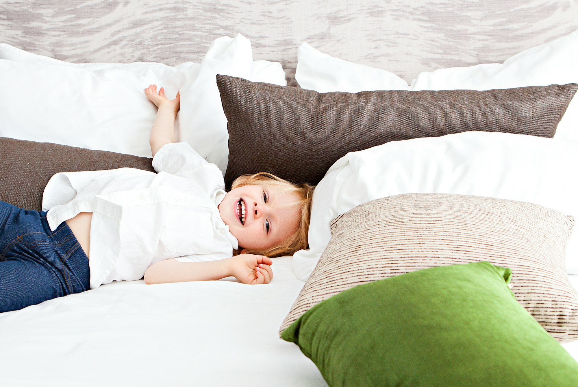 This image was taken for my client, Nannybird—an LA-based nanny service. I shot at a chic hotel in Hollywood and lucked out with the all-white walls that served as a fabulous bounce card for the floor to ceiling windows that had gorgeous afternoon light streaming in. The child had an absolute blast knocking down all of the pillows on the perfectly-made hotel bed, and I managed to catch him perfectly in the act.  ; )