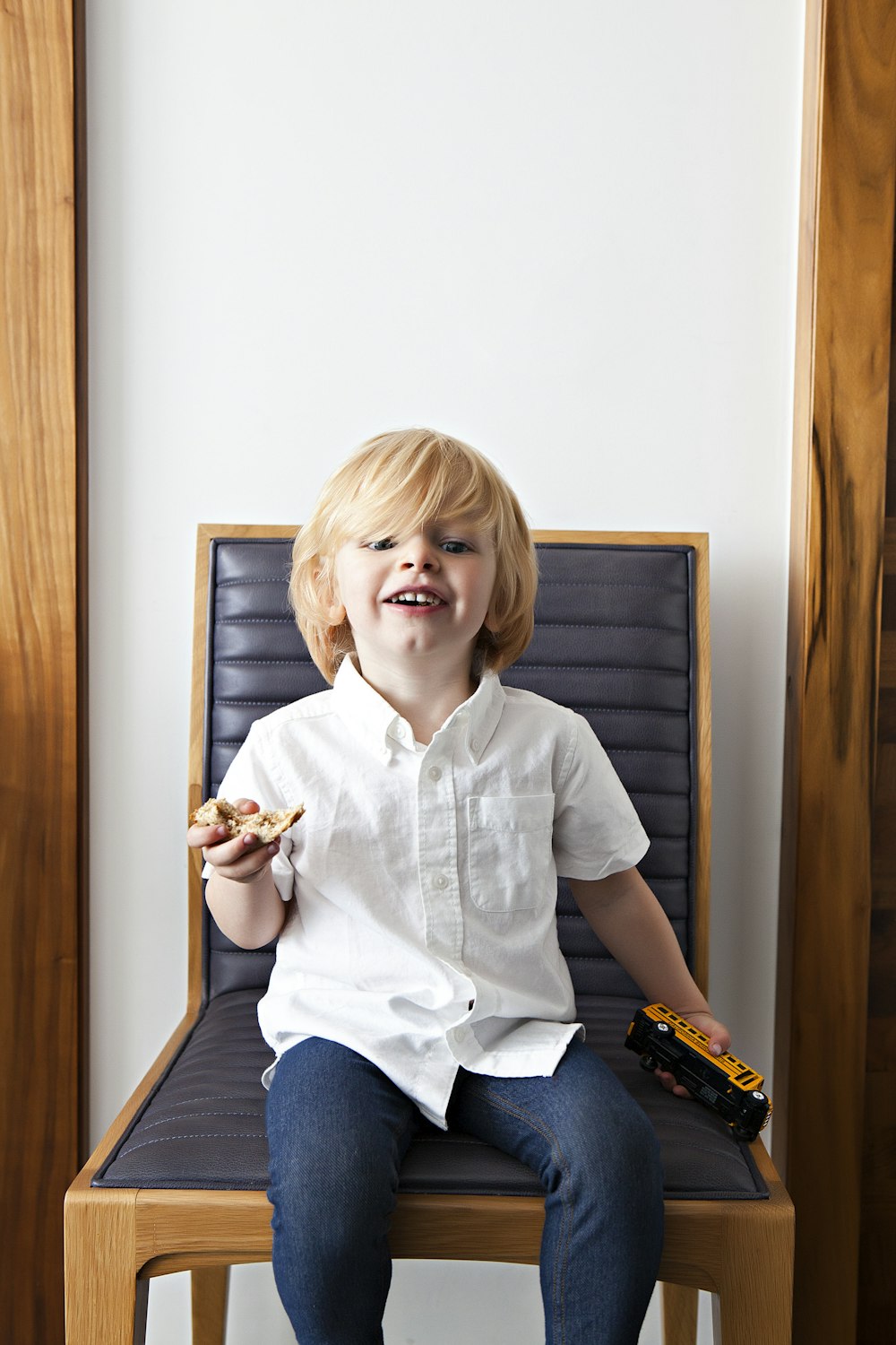 boy sitting on black padded chair