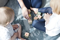 two toddler playing letter cubes