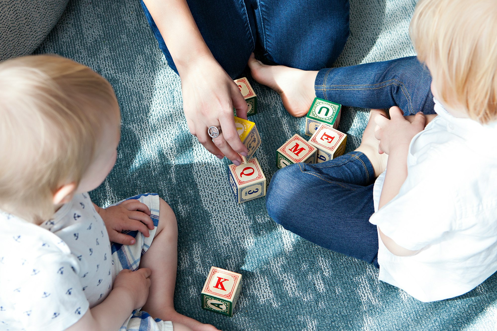 This image was taken for my client, Nannybird—an LA-based nanny service. I shot at a chic hotel in Hollywood and lucked out with the all-white walls that served as a fabulous bounce card for the floor to ceiling windows that had gorgeous afternoon light streaming in. This image was a detail shot for the day, showcasing one of the nannies playing blocks with the children, who were both eagerly engaged—a rare moment for the rambunctious ones!  ; )