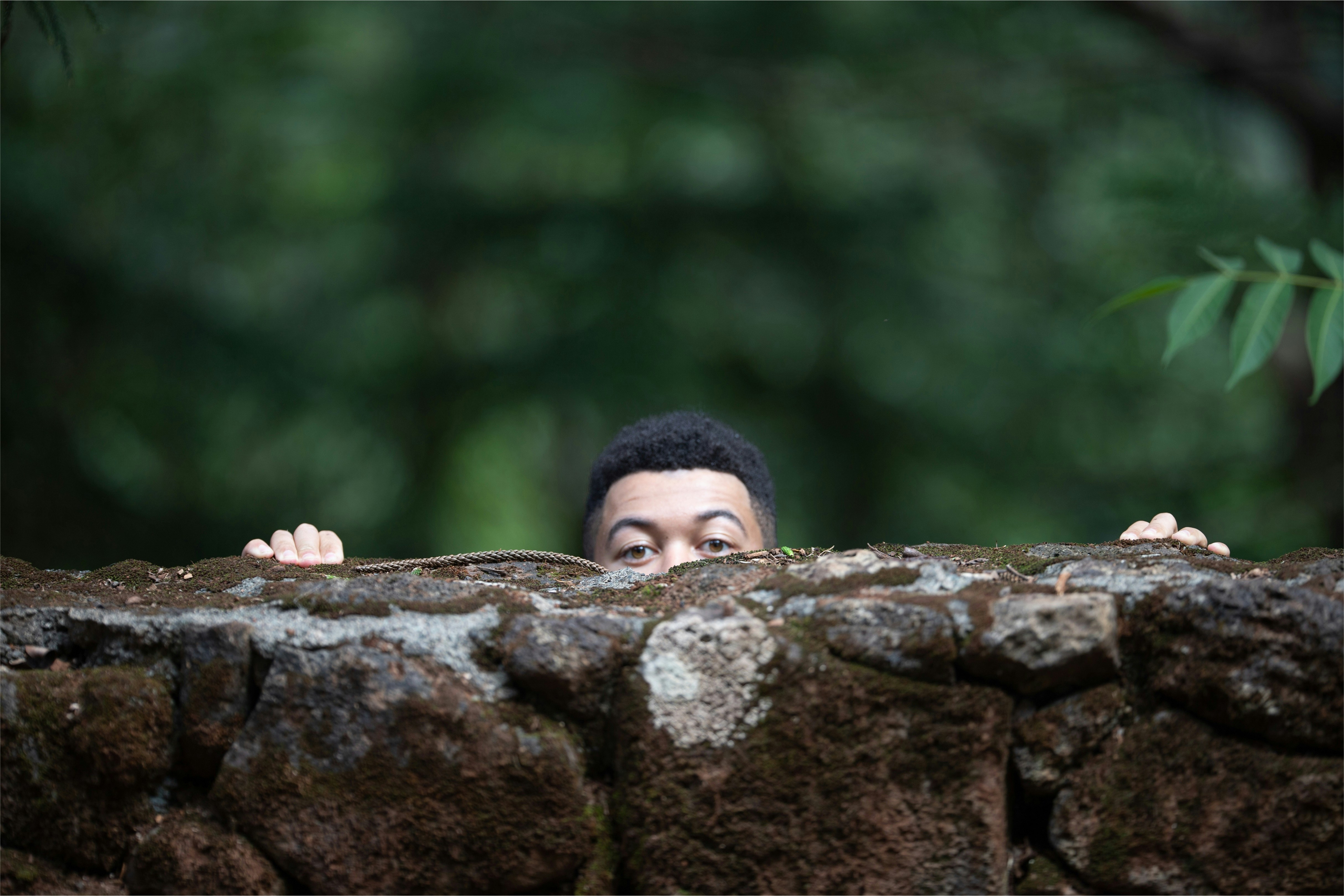 man behind \brown rock