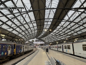 A panoramic view of a modern railway station with sleek design.