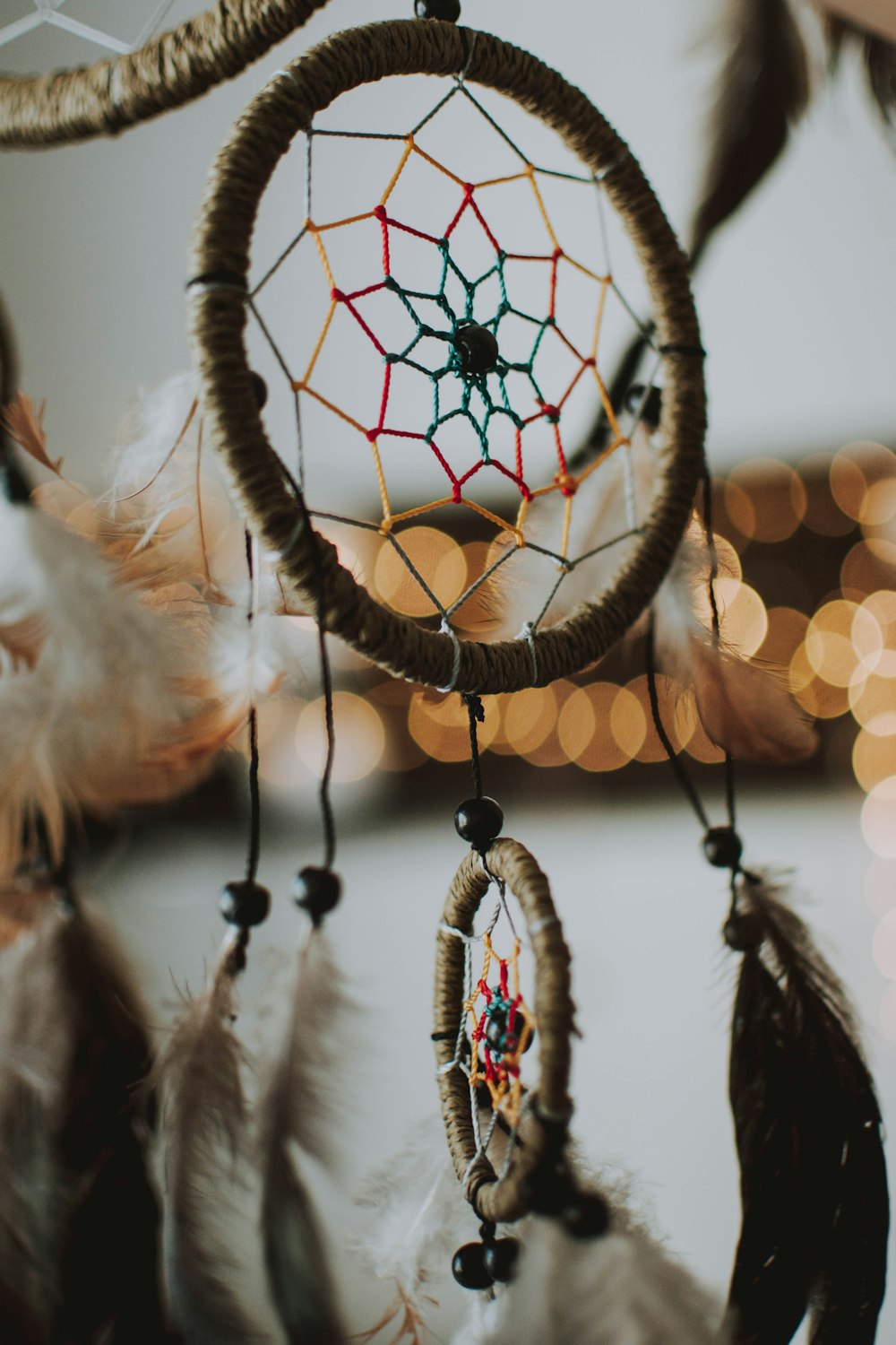 selective focus photography of brown and multicolored dream catcher
