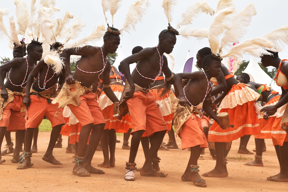 people dancing on brown soil